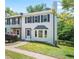 Beautiful two-story townhouse featuring an inviting entrance, dark shutters, and a lush green lawn at 1505 Cedar Bluff Trl, Marietta, GA 30062
