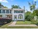 Charming two-story townhouse with a well-manicured lawn and freshly painted white exterior at 1505 Cedar Bluff Trl, Marietta, GA 30062