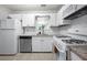 Well lit kitchen features white cabinets, stainless steel dishwasher and gas range oven at 1505 Cedar Bluff Trl, Marietta, GA 30062