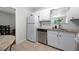Clean kitchen features a stainless steel dishwasher, white cabinets, and light countertops at 1505 Cedar Bluff Trl, Marietta, GA 30062