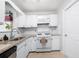 Well lit kitchen features white cabinets, stainless steel microwave and gas range oven at 1505 Cedar Bluff Trl, Marietta, GA 30062