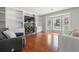 Bright living room featuring hardwood floors, a fireplace, a comfortable sofa, and an armchair at 1505 Cedar Bluff Trl, Marietta, GA 30062