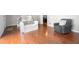 Hardwood floors accent this open living room with comfortable seating and ample natural light at 1505 Cedar Bluff Trl, Marietta, GA 30062