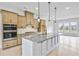 Modern kitchen with stainless appliances, light wood cabinetry, island with quartz countertop at 2611 Alcovy Ne Trl, Marietta, GA 30066