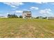 Spacious backyard showing the home's exterior and covered back porch and deck at 294 Ralph Still Rd, Dacula, GA 30019