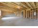 Spacious unfinished basement featuring concrete flooring, framed walls, and stairs at 294 Ralph Still Rd, Dacula, GA 30019