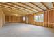 Unfinished basement showcasing the framing, concrete floor, and window at 294 Ralph Still Rd, Dacula, GA 30019