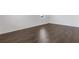 Bedroom featuring laminate wood flooring, white walls, baseboards, and trim at 294 Ralph Still Rd, Dacula, GA 30019