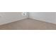 Bedroom features a window for natural light and neutral-toned carpeting at 294 Ralph Still Rd, Dacula, GA 30019