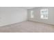 This well-lit bedroom offers two large windows and neutral carpet, creating a comfortable atmosphere at 294 Ralph Still Rd, Dacula, GA 30019