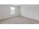 Bright bedroom featuring neutral carpeting, white walls, and a window with blinds at 294 Ralph Still Rd, Dacula, GA 30019