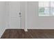 Entryway featuring laminate wood flooring, white door and walls, and a window with white blinds at 294 Ralph Still Rd, Dacula, GA 30019