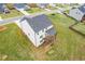 Aerial view of home's backyard featuring a wooden deck and green lawn at 294 Ralph Still Rd, Dacula, GA 30019