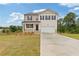 Charming two-story home featuring neutral siding, black shutters, a two-car garage, and a well manicured lawn at 294 Ralph Still Rd, Dacula, GA 30019