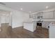 Open kitchen with island, stainless steel appliances, granite countertops, and wood flooring at 294 Ralph Still Rd, Dacula, GA 30019