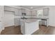 Well-lit kitchen with granite countertops, stainless steel appliances, and grey cabinets at 294 Ralph Still Rd, Dacula, GA 30019