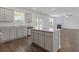 Spacious kitchen with granite island, stainless steel appliances, and adjacent living area at 294 Ralph Still Rd, Dacula, GA 30019