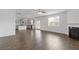 Open concept living room with kitchen view, featuring a fireplace and hardwood floors at 294 Ralph Still Rd, Dacula, GA 30019