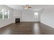 Open concept living room featuring a fireplace, hardwood floors, and natural light at 294 Ralph Still Rd, Dacula, GA 30019
