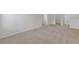 Upstairs loft featuring neutral carpet with multiple entryways and natural light at 294 Ralph Still Rd, Dacula, GA 30019
