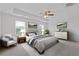 Staged main bedroom features neutral tones, decorative art, and a sitting area for a calm space at 294 Ralph Still Rd, Dacula, GA 30019