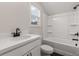 Bathroom with a combination tub/shower, a white sink, and dark hardware for a modern contrast at 3723 Silvery Way, Powder Springs, GA 30127