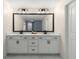 Double sink vanity with white countertop, black hardware, framed mirror, and white cabinets at 3723 Silvery Way, Powder Springs, GA 30127