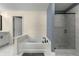 Bathroom with a tub and a tile shower with a glass door, perfect for a relaxing and modern experience at 3723 Silvery Way, Powder Springs, GA 30127