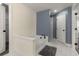 Well-lit bathroom with a standalone tub, tiled floors, shower, and neutral walls at 3723 Silvery Way, Powder Springs, GA 30127