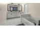 Bathroom featuring a double sink vanity with a large mirror, stand alone tub, and modern lighting fixtures at 3723 Silvery Way, Powder Springs, GA 30127