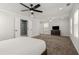 Spacious bedroom features a ceiling fan, ensuite bath with shower, and large windows for ample natural light at 3723 Silvery Way, Powder Springs, GA 30127