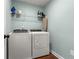 Laundry room features a modern washer and dryer and wire shelving at 3723 Silvery Way, Powder Springs, GA 30127