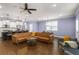 Spacious living room and kitchen area with hardwood floors, modern lighting and barstool seating at 3723 Silvery Way, Powder Springs, GA 30127