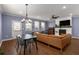 Open-concept living room with fireplace, hardwood floors, and dining table with seating for four at 3723 Silvery Way, Powder Springs, GA 30127