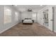 Large bedroom with hardwood floor, many windows, and neutral decor at 3723 Silvery Way, Powder Springs, GA 30127
