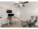 Bright office space featuring a desk, comfortable chair, and a view to the upstairs landing at 3723 Silvery Way, Powder Springs, GA 30127