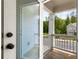 View of the cozy covered porch area with wooden floors and white pillars at 3723 Silvery Way, Powder Springs, GA 30127