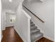 Hallway with a wooden stairway, gray carpet, and hardwood floors at 3723 Silvery Way, Powder Springs, GA 30127
