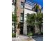 Modern townhome with a combination of brick and white facade, accented by lush greenery and a pergola at 721 Longleaf Ne Dr # 3, Atlanta, GA 30342