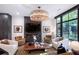 An interior shot reveals a modern living room with a fireplace, plush seating, and a large window at 721 Longleaf Ne Dr # 3, Atlanta, GA 30342
