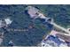 Aerial shot showcasing the land for sale at 9675 Almaviva Dr, surrounded by mature trees at 9675 Almaviva Dr, Alpharetta, GA 30022