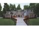 Stunning two-story home with manicured lawn and beautiful brick and stone exterior at 9675 Almaviva Dr, Alpharetta, GA 30022