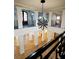 An open foyer showing the second floor balcony with decorative railings and a modern chandelier hanging from the ceiling at 9675 Almaviva Dr, Alpharetta, GA 30022