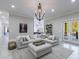 Spacious living room with large sectional sofa, decorative lighting, and double glass doors to the outside patio at 9675 Almaviva Dr, Alpharetta, GA 30022