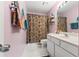 Well-lit bathroom with white vanity, floral shower curtain, and pink walls at 62 Mount Vernon Cir, Atlanta, GA 30338
