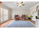 Cozy living room featuring a large window, hardwood floors, and comfortable seating area at 62 Mount Vernon Cir, Atlanta, GA 30338