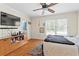 Spacious bedroom with hardwood floors, ceiling fan, and a large window at 62 Mount Vernon Cir, Atlanta, GA 30338