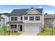 Charming two-story home with a brick facade, attached garage, and beautifully landscaped front yard at 8605 Secretariat Dr, Lithonia, GA 30058