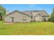 Backyard view of a single-Gathering home with a patio and grassy lawn at 1282 Berryhill Dr, Lithonia, GA 30058
