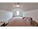 Large bonus room with neutral carpet, small window and sloped ceiling at 1282 Berryhill Dr, Lithonia, GA 30058